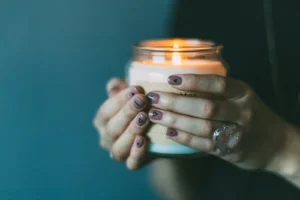 person holding white candle with light