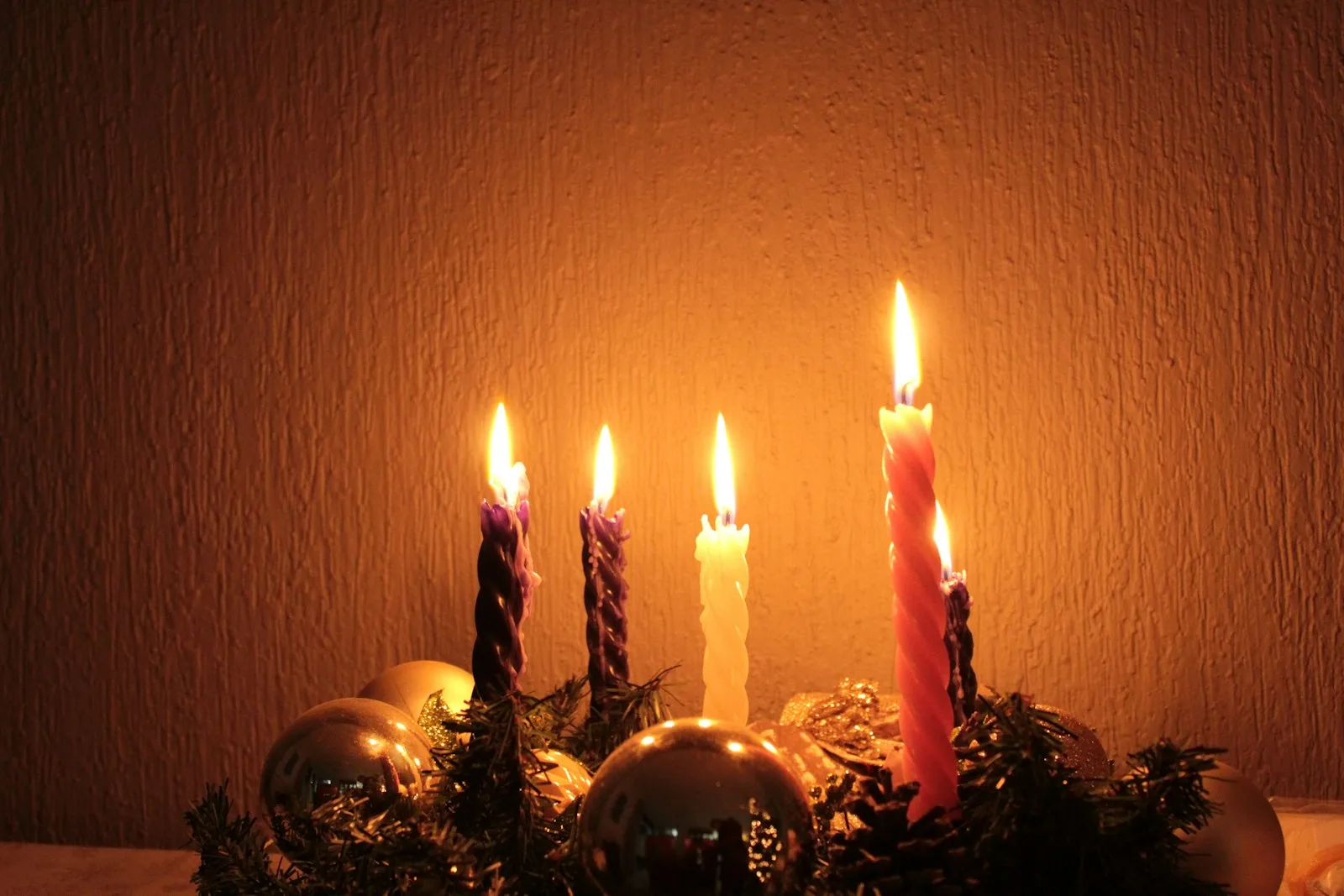 a group of lit candles sitting on top of a table