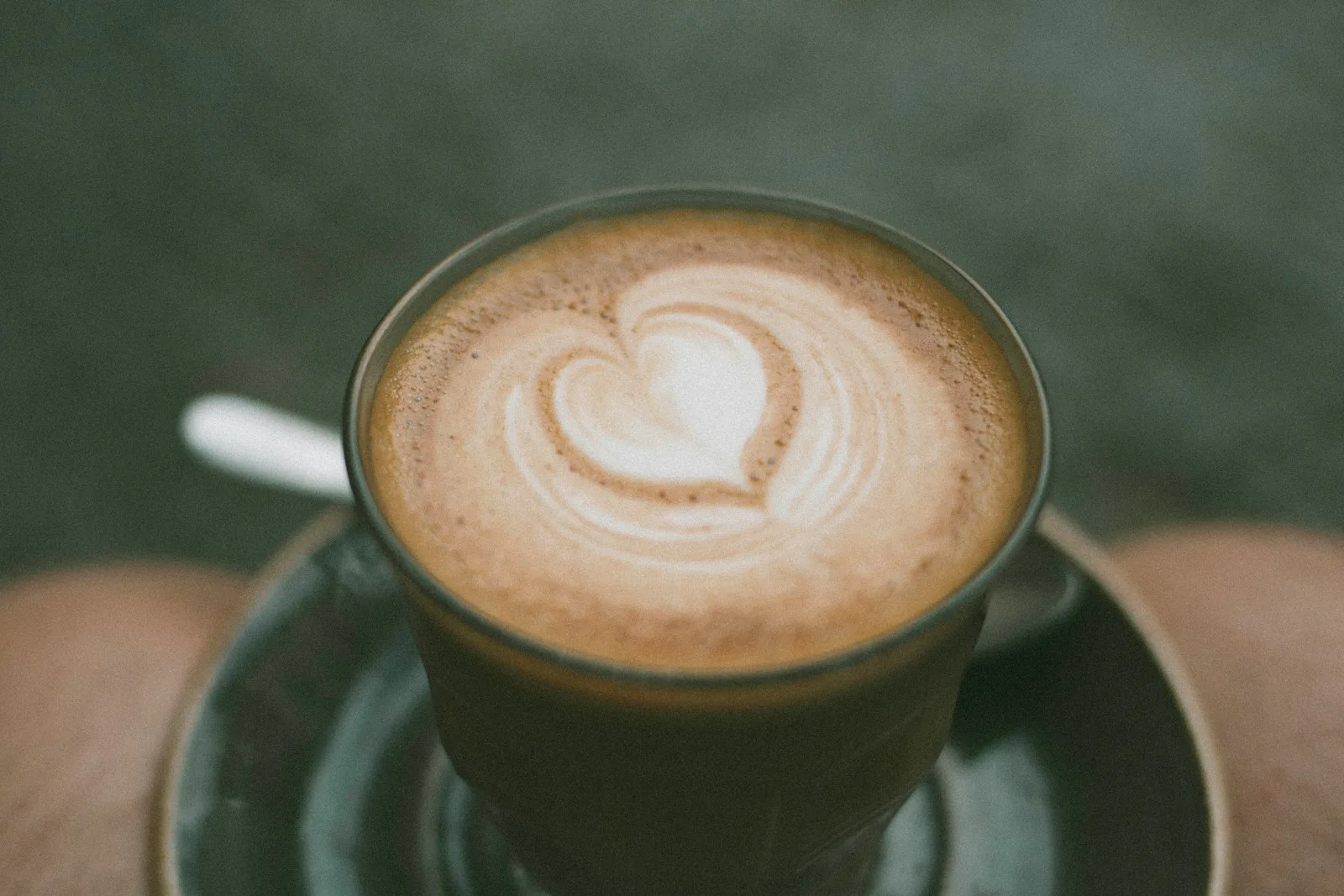 closeup photo of ceramic coffee mug with brown liquid inside