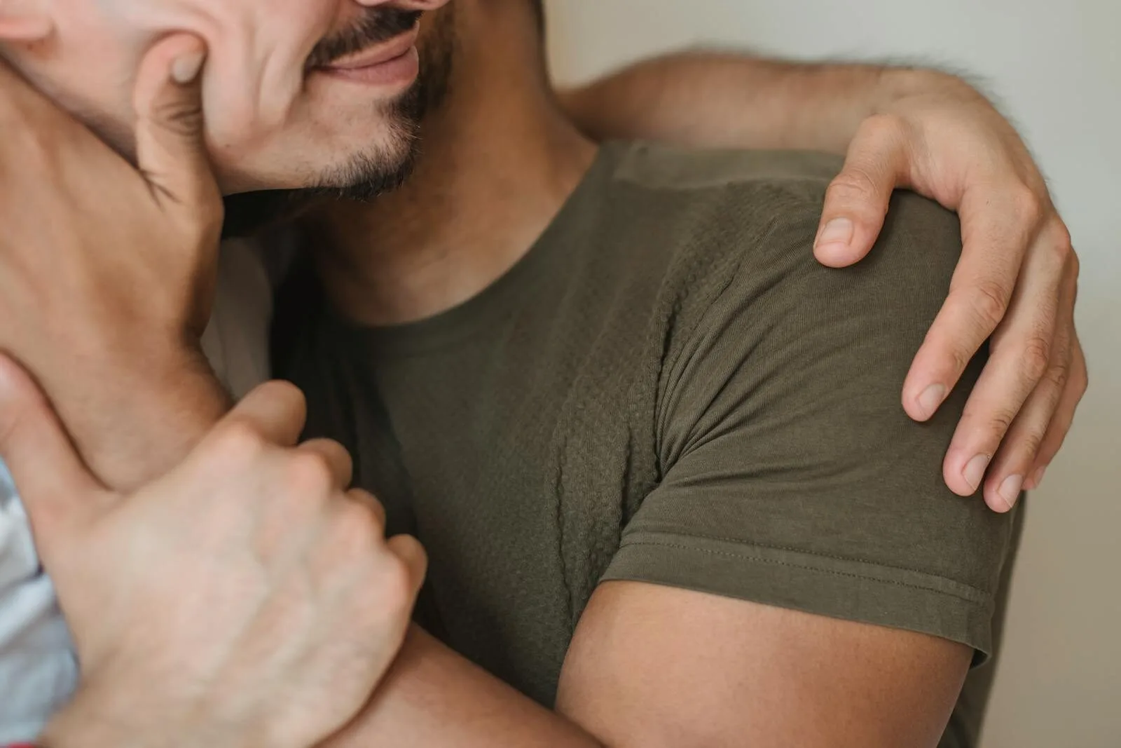 A heartfelt close-up of two men embracing, symbolizing love and connection.