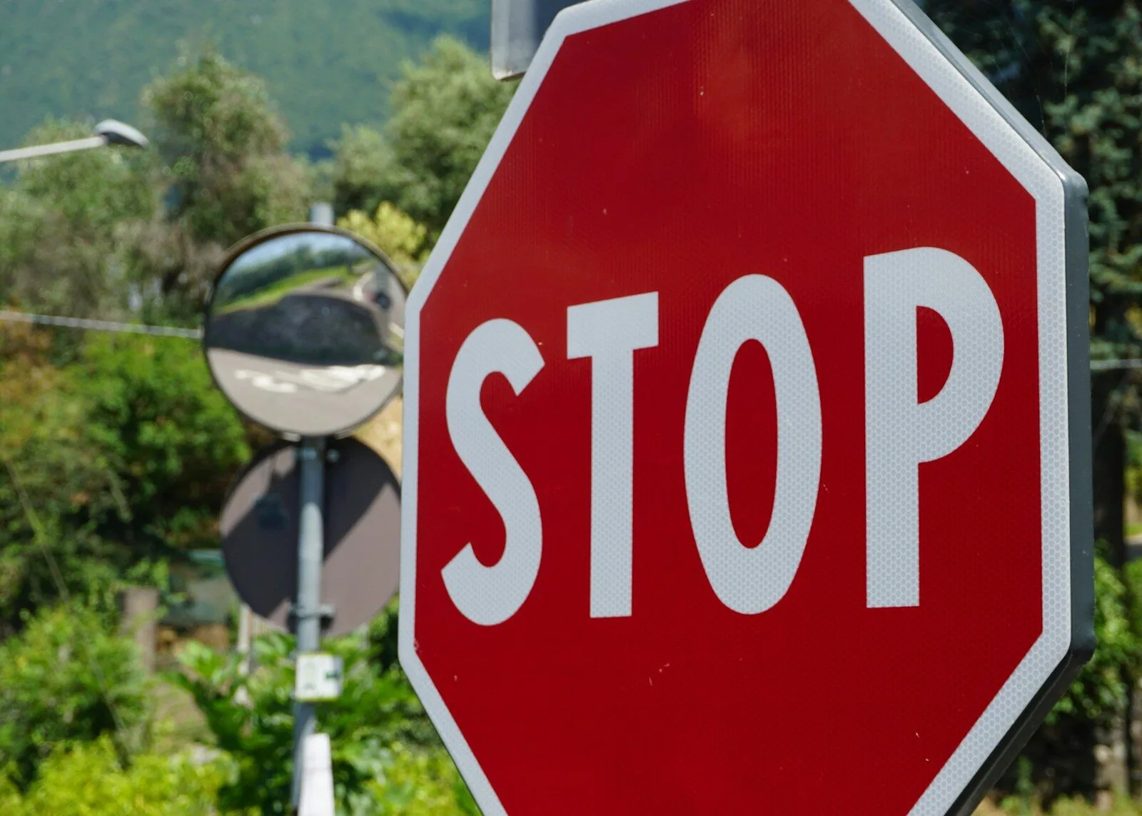 a red stop sign sitting next to a street light