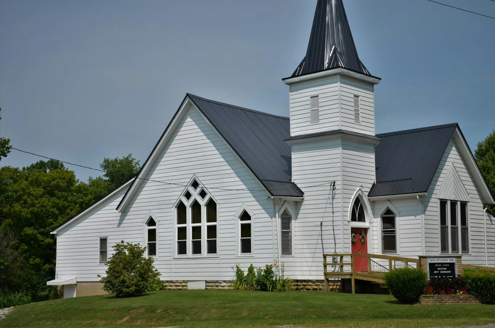 white and black church under gray sky