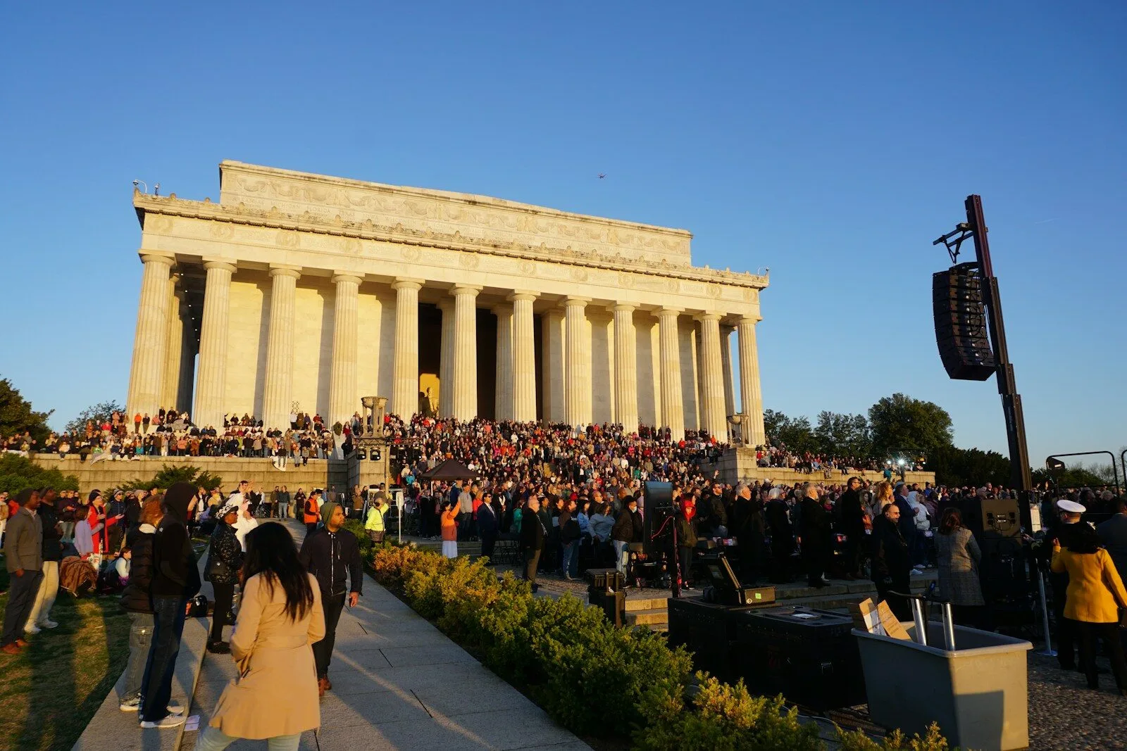 a crowd of people standing in front of a building