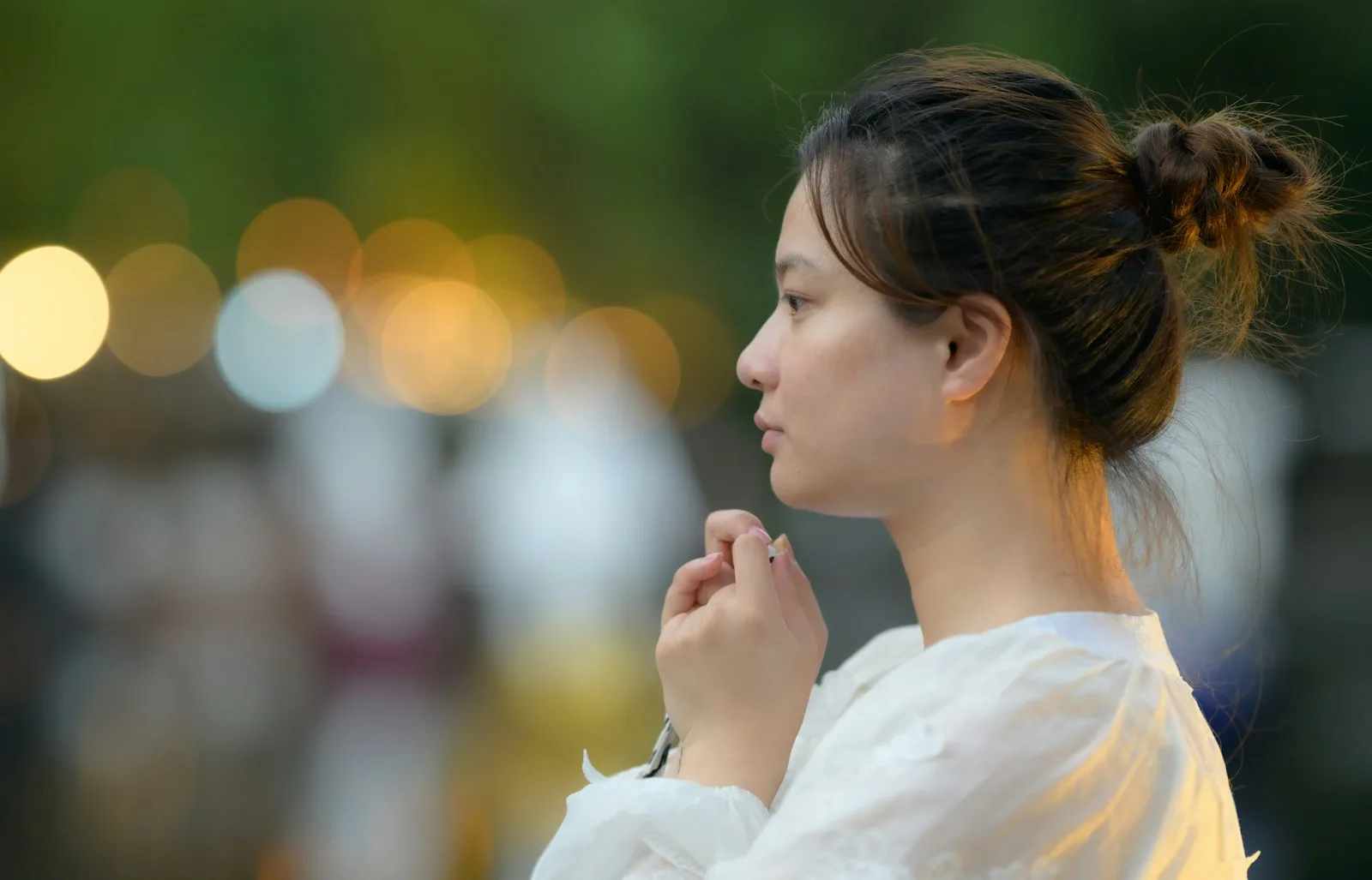 A woman in a white dress standing in the street