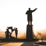 Silhouette of a Lenin monument in Nizhny Novgorod, Russia during sunset with a warm backlit effect.